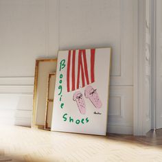 a pair of pink shoes are on display in front of a white wall and wooden floor