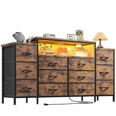 a large wooden dresser with drawers and lights on it's top shelf next to a lamp