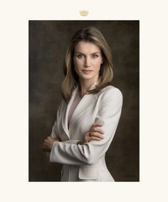 a woman with her arms crossed posing for a photo