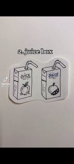 two juice boxes stickers with the words juice and apple in black ink on white paper