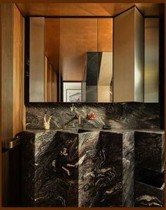 a bathroom with marble counter tops and cabinets