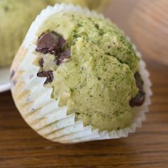 there are two muffins with chocolate chips in them sitting on the table next to each other