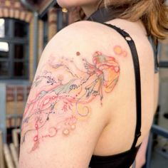 a woman with a tattoo on her shoulder