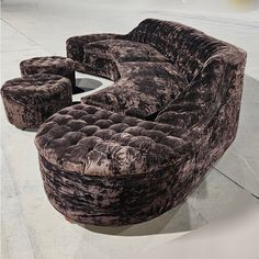 a couch and two stools are shown in this image