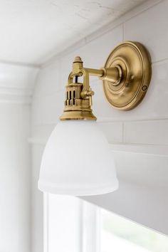 an old fashioned light fixture in a bathroom