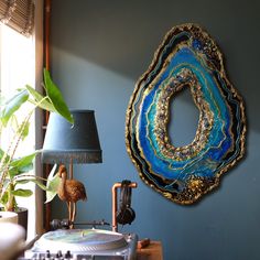 a record player sitting on top of a table next to a lamp