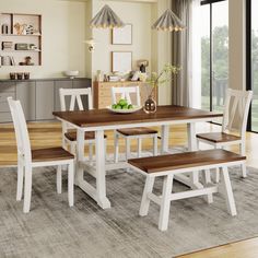 a dining room table with four chairs and a bench