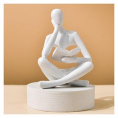 a white sculpture sitting on top of a table