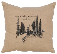 a pillow with the words not all who wander are lost on it, and trees in the background