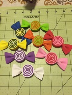 several different colored bow ties on a cutting board