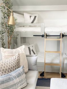 a room with bunk beds and pillows on the floor