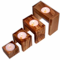 three wooden candles sitting next to each other