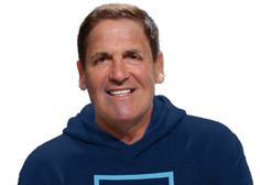 a man in a blue hoodie smiling at the camera