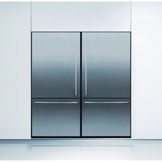 two stainless steel refrigerators sitting side by side in a white room with light floors