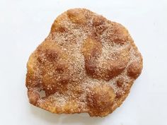 a pastry with powdered sugar on it sitting on top of a white tablecloth