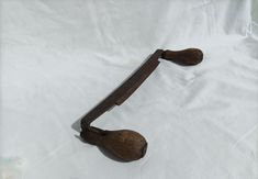 an old wooden handle on a white sheet