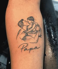 a tattoo on the arm of a man with a woman holding him in his arms