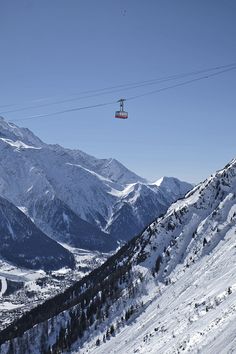 a ski lift in the middle of a snowy mountain range