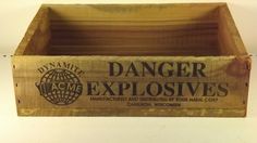 a wooden box with the words danger explosives written on it and an earth globe inside