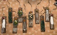 wooden signs with christmas decorations hanging from them on a brown tablecloth covered floor and polka dot background