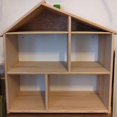 a doll house made out of wooden shelves