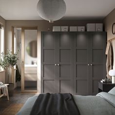 a bedroom with dark gray cabinets and white lights on the ceiling, along with a large bed