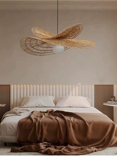 a large bed sitting under a light fixture in a bedroom