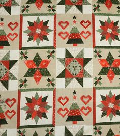 a christmas quilt with red, green and white decorations