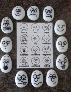 a bunch of buttons with faces on them and some words written in the middle one