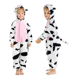 two children dressed in costumes standing next to each other, one wearing a cow costume