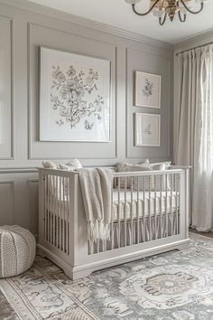 a baby's room with a crib, rug and pictures on the wall