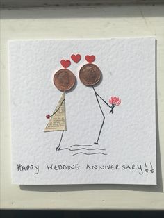 a card with two coins on top of it and the words happy wedding anivere say