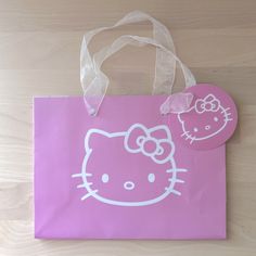 a pink hello kitty bag with a white hello kitty sticker on it