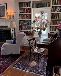 a living room filled with lots of furniture and bookshelves full of bookcases