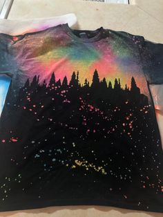 a t - shirt with trees painted on it