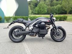 a black motorcycle parked in a parking lot