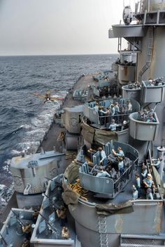 the battleship is full of people on it's deck