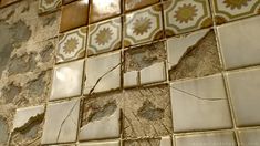 an old tile wall with peeling paint and cracks in the middle, showing some damage