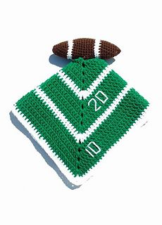 a green and white crocheted football jersey with the number twenty seven on it