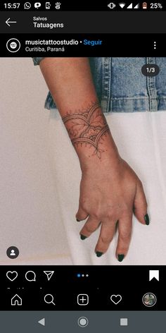 a person's hand with a small tattoo on their left wrist and the other arm