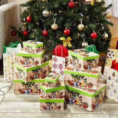 christmas presents are stacked up in front of a christmas tree