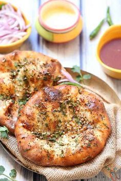 two small pizzas sitting on top of a plate