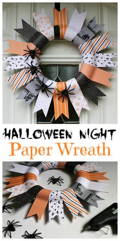 a halloween wreath made out of paper with bats and spider webs