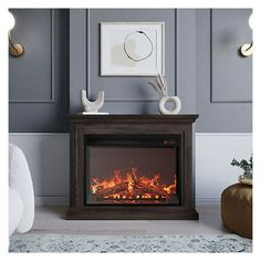 an electric fireplace in a living room with grey walls and white carpeted flooring