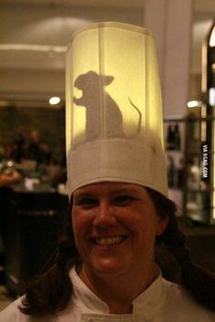 a woman wearing a white hat with a shadow of a mouse on it