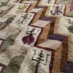 a multicolored area rug with various designs on it