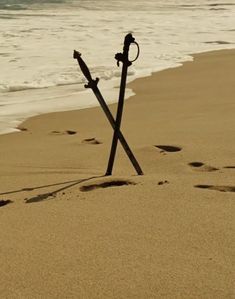 two crosses are placed in the sand at the beach