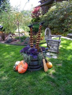 halloween decorations in the yard with pumpkins and brooms