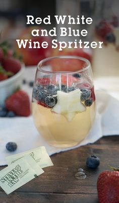 red white and blue wine spritzer in a glass with strawberries on the side