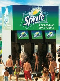 a group of people standing in front of a sprite water dispenser